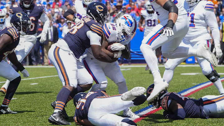 Montez Sweat and Austin Booker make a tackle against the Bills in preseason. Sweat says he is ready to chase QBs and finish with sacks.