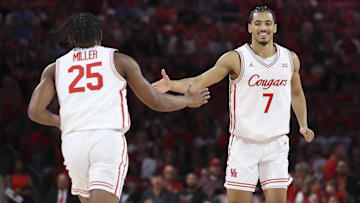 Dec 13, 2025; Houston, Texas, USA; Houston Cougars guard Milos Uzan (7) celebrates with guard Mercy Miller (25) after a play during the first half against the New Orleans Privateers at Fertitta Center. 