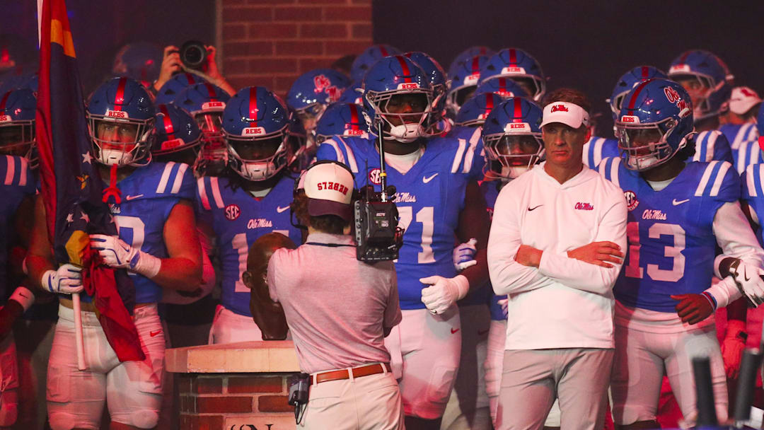 Nov 15, 2025; Oxford, Mississippi, USA; Mississippi Rebels head coach Lane Kiffin stands with his players before a game against the Florida Gators at Vaught-Hemingway Stadium. Mandatory Credit: Petre Thomas-Imagn Images