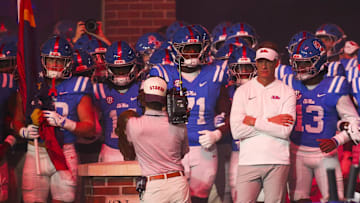 Nov 15, 2025; Oxford, Mississippi, USA; Mississippi Rebels head coach Lane Kiffin stands with his players before a game against the Florida Gators at Vaught-Hemingway Stadium. Mandatory Credit: Petre Thomas-Imagn Images