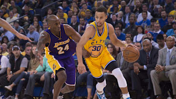 November 24, 2015; Oakland, CA, USA; Golden State Warriors guard Stephen Curry (30) dribbles the basketball against Los Angeles Lakers forward Kobe Bryant (24) during the third quarter at Oracle Arena. The Warriors defeated the Lakers 111-77. Mandatory Credit: Kyle Terada-Imagn Images