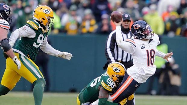 Chicago Bears quarterback Caleb Williams (18) throws an incomplete pass as he is tackled by Green Bay Packers linebacker Edge Chicago Bears quarterback Caleb Williams (18) throws an incomplete pass as he is tackled by Green Bay Packers linebacker Edge