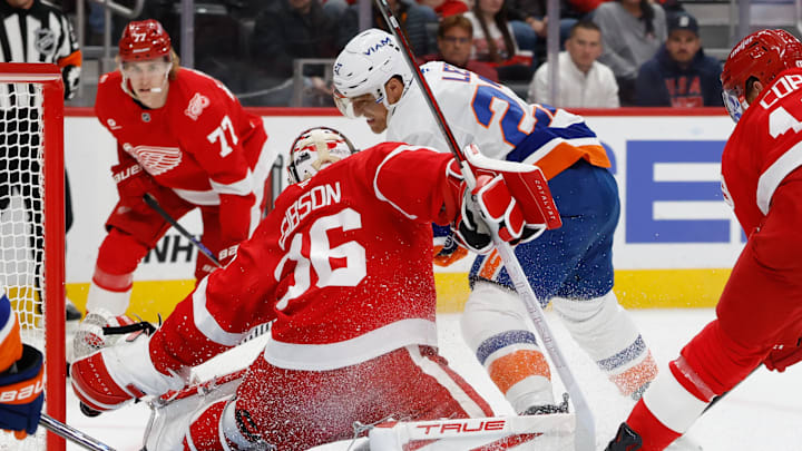 Dec 16, 2025; Detroit, Michigan, USA;  Detroit Red Wings goaltender John Gibson (36) makes the save on New York Islanders left wing Anders Lee (27) in the first period at Little Caesars Arena. Mandatory Credit: Rick Osentoski-Imagn Images