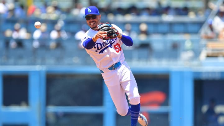 Jun 16, 2024; Los Angeles, California, USA; Los Angeles Dodgers shortstop Mookie Betts (50) throws to first for the out against Kansas City Royals catcher Freddy Fermin (34) during the second inning at Dodger Stadium. Mandatory Credit: Gary A. Vasquez-USA TODAY Sports