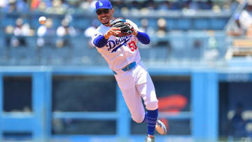 Jun 16, 2024; Los Angeles, California, USA; Los Angeles Dodgers shortstop Mookie Betts (50) throws to first for the out against Kansas City Royals catcher Freddy Fermin (34) during the second inning at Dodger Stadium. Mandatory Credit: Gary A. Vasquez-USA TODAY Sports