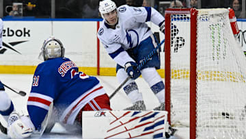 Apr 7, 2025; New York, New York, USA;  Tampa Bay Lightning center Brayden Point (21) takes a shot and scores his second goal of the game against New York Rangers goaltender Igor Shesterkin (31) during the third period at Madison Square Garden. Mandatory Credit: Dennis Schneidler-Imagn Images