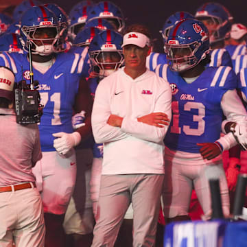 Nov 15, 2025; Oxford, Mississippi, USA; Mississippi Rebels head coach Lane Kiffin stands with his players before a game against the Florida Gators at Vaught-Hemingway Stadium. Mandatory Credit: Petre Thomas-Imagn Images