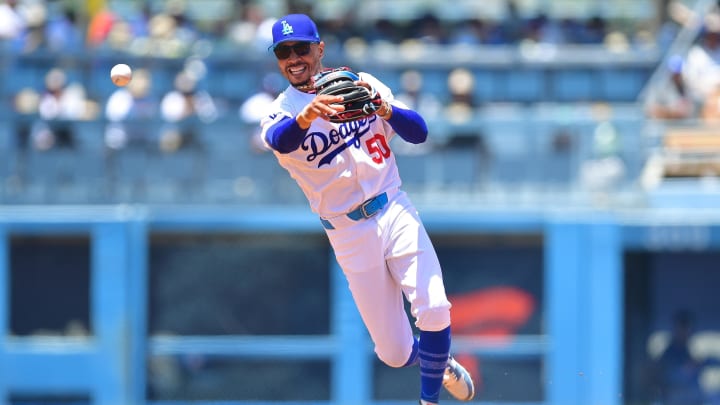 Jun 16, 2024; Los Angeles, California, USA; Los Angeles Dodgers shortstop Mookie Betts (50) throws to first for the out against Kansas City Royals catcher Freddy Fermin (34) during the second inning at Dodger Stadium. Mandatory Credit: Gary A. Vasquez-USA TODAY Sports