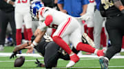 Oct 5, 2025; New Orleans, Louisiana, USA; New Orleans Saints defensive end Cameron Jordan (94) recovers a fumble in front of New York Giants quarterback Jaxson Dart (6) during the third quarter at Caesars Superdome.  