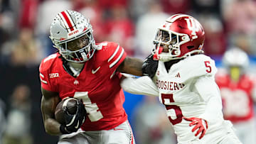 Ohio State Buckeyes wide receiver Jeremiah Smith (4) shakes off Indiana Hoosiers defensive back D'Angelo Ponds (5) during the Big Ten Conference championship game at Lucas Oil Stadium in Indianapolis on Dec. 6, 2025. Ohio State lost 13-10.
