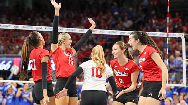 Nebraska players celebrate a point against No. 18 Creighton.