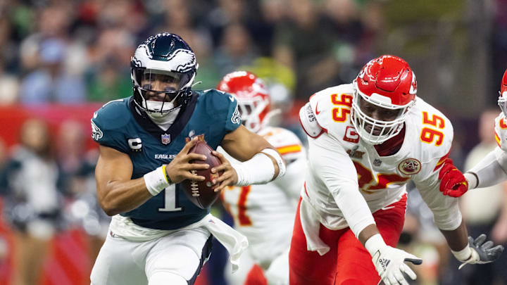 Philadelphia Eagles quarterback Jalen Hurts is pressured by Kansas City Chiefs defensive tackle Chris Jones during Super Bowl LIX at Ceasars Superdome.