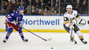 Dec 7, 2025; New York, New York, USA;  New York Rangers left wing Alexis Lafrenière (13) and Vegas Golden Knights center Jack Eichel (9) chase the puck in the third period at Madison Square Garden. Mandatory Credit: Wendell Cruz-Imagn Images