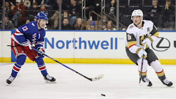 Dec 7, 2025; New York, New York, USA;  New York Rangers left wing Alexis Lafrenière (13) and Vegas Golden Knights center Jack Eichel (9) chase the puck in the third period at Madison Square Garden. Mandatory Credit: Wendell Cruz-Imagn Images