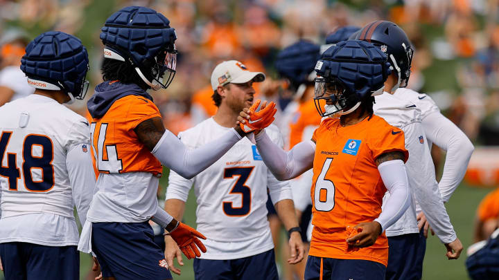 Jul 26, 2024; Englewood, CO, USA; Denver Broncos wide receiver Courtland Sutton (14) and safety P.J. Locke (6) during training camp at Broncos Park Powered by CommonSpirit. 