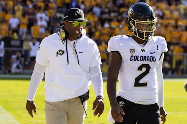 Oct 7, 2023; Tempe, Arizona, USA; Colorado Buffaloes head coach Deion Sanders with son and quarterback Shedeur Sanders (2) ag