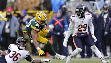 Jan 5, 2025; Green Bay, Wisconsin, USA; Green Bay Packers running back Chris Brooks (30) runs for a first down against Chicago Bears safety Jonathan Owens (36) and cornerback Tyrique Stevenson (29) during their football game Sunday, January 5, 2025 at Lambeau Field. Mandatory Credit: Dan Powers USA TODAY NETWORK-Wisconsin