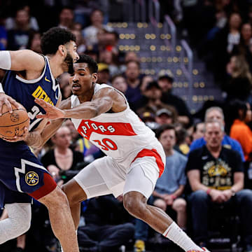 Mar 11, 2024; Denver, Colorado, USA; Denver Nuggets guard Jamal Murray (27) controls the ball as Toronto Raptors guard Ochai Agbaji (30) guards in the first quarter at Ball Arena. Mandatory Credit: Isaiah J. Downing-Imagn Images