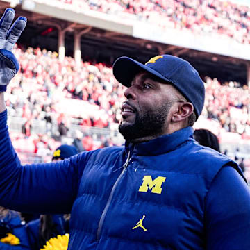Michigan head coach Sherrone Moore uses a hand signal to celebrate the Wolverines' fourth straight win over Ohio State