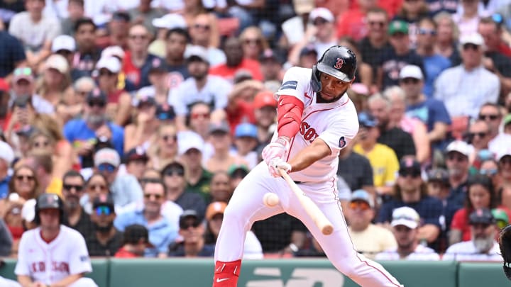 Aug 11, 2024; Boston, Massachusetts, USA; Boston Red Sox first baseman Dominic Smith (2) hits a single against the Houston Astros during the fifth inning at Fenway Park. Mandatory Credit: Eric Canha-USA TODAY Sports