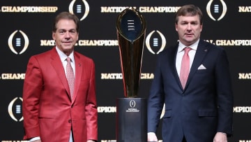 Former Alabama Crimson Tide coach Nick Saban and Georgia Bulldogs coach Kirby Smart with the College Football Playoff trophy