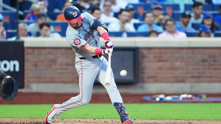 Jul 10, 2024; New York City, New York, USA; Washington Nationals right fielder Lane Thomas (28) hits a single against the New York Mets during the fourth inning at Citi Field.