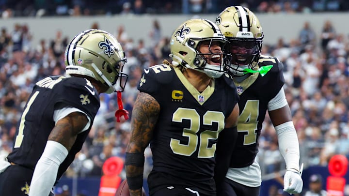 Sep 15, 2024; Arlington, Texas, USA; New Orleans Saints safety Tyrann Mathieu (32) celebrates with New Orleans Saints cornerback Alontae Taylor (1) and New Orleans Saints cornerback Kool-Aid McInstry(14) after making an interception during the second half against the Dallas Cowboys at AT&T Stadium. Mandatory Credit: Kevin Jairaj-Imagn Images