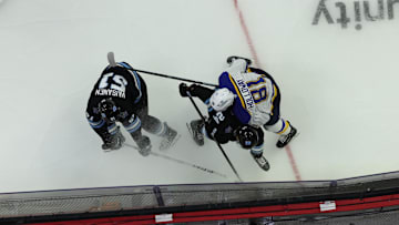 Sep 22, 2024; Des Moines, Iowa, USA; St. Louis Blues center Dylan Holloway (81) battles Utah Hockey Club forward Cole Beaudoin (24) and Utah Hockey Club defenseman Veeti Vaisanen (51) for a lose puck at Wells Fargo Arena. Mandatory Credit: Reese Strickland-Imagn Images

