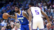 Apr 5, 2023; Dallas, Texas, USA;  Dallas Mavericks guard Kyrie Irving (2) controls the ball as Sacramento Kings guard De'Aaron Fox (5) defends during the first quarter at American Airlines Center. Mandatory Credit: Kevin Jairaj-Imagn Images