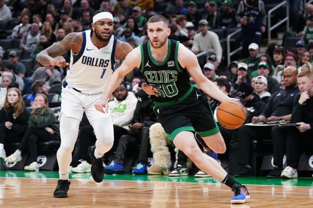 Boston Celtics guard Svi Mykhailiuk (50) drives the ball against Dallas Mavericks guard Jaden Hardy (1).