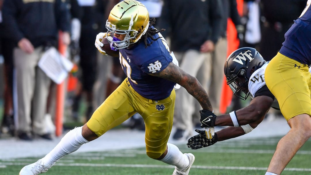 Nov 18, 2023; South Bend, Indiana, USA; Notre Dame Fighting Irish wide receiver Rico Flores Jr. (17) runs after the catch as Wake Forest Demon Deacons safety Chelen Garnes (9) defends in the second quarter at Notre Dame Stadium. Mandatory Credit: Matt Cashore-USA TODAY Sports