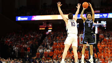 Feb 17, 2025; Charlottesville, Virginia, USA; Duke basketball guard Tyrese Proctor (5) shoots the ball as Virginia Cavaliers guard Taine Murray (10) defends in the first half at John Paul Jones Arena.