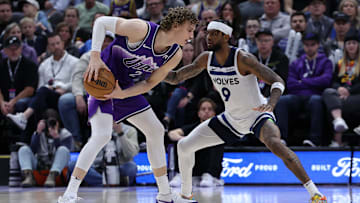 Mar 18, 2024; Salt Lake City, Utah, USA; Utah Jazz forward Lauri Markkanen (23) looks to move the ball against Minnesota Timberwolves guard Nickeil Alexander-Walker (9) during the fourth quarter at Delta Center. Mandatory Credit: Rob Gray-Imagn Images
