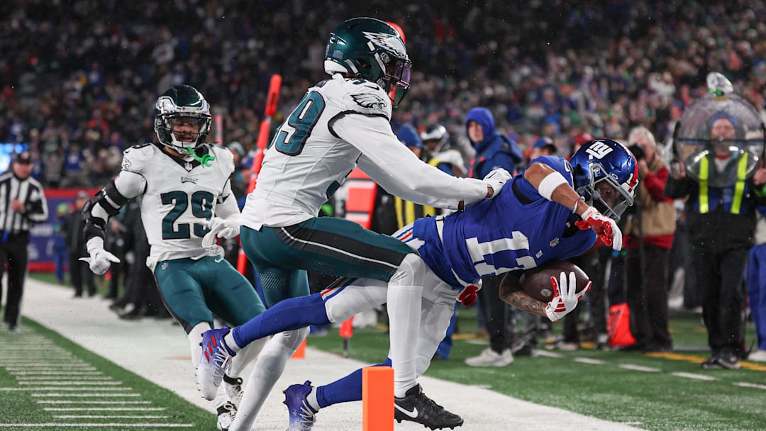 Jan 7, 2024; East Rutherford, New Jersey, USA; New York Giants wide receiver Wan'Dale Robinson (17) is tackled before the pylon by Philadelphia Eagles cornerback Eli Ricks (39) pursues during the first half at MetLife Stadium. Mandatory Credit: Vincent Carchietta-Imagn Images