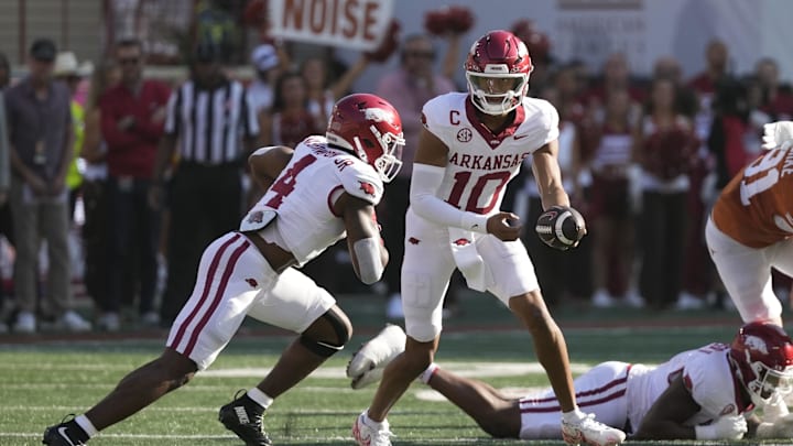 Nov 22, 2025; Austin, Texas, USA; Arkansas Razorbacks quarterback Taylen Green (10) hands the ball off to running back Mike Washington Jr. (4) during the first half against the Texas Longhorns at Darrell K Royal-Texas Memorial Stadium. Mandatory Credit: Scott Wachter-Imagn Images