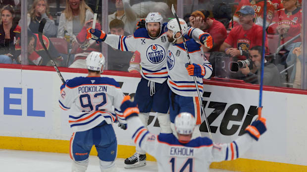 Hockey players celebrate an overtime goal