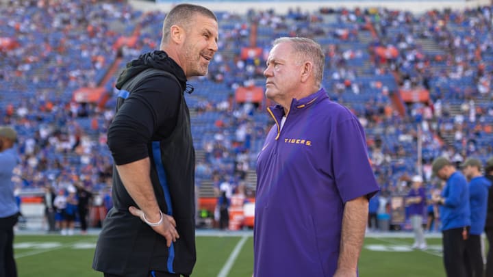 Nov 16, 2024; Gainesville, Florida, USA; Florida Gators head coach Billy Napier and LSU Tigers head coach Brian Kelly talk midfield before a game at Ben Hill Griffin Stadium. Mandatory Credit: Matt Pendleton-Imagn Images