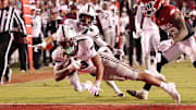 Mississippi State Bulldogs wide receiver Anthony Evans III (3) scores a touchdown during the fourth quarter against the Arkansas Razorbacks at Donald W. Reynolds Razorback Stadium. Bulldogs won 38-35.
