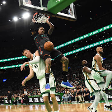 Washington Wizards forward Kyle Kuzma (33) dunks the ball past Boston Celtics center Kristaps Porzingis (8) during the first half at TD Garden. 