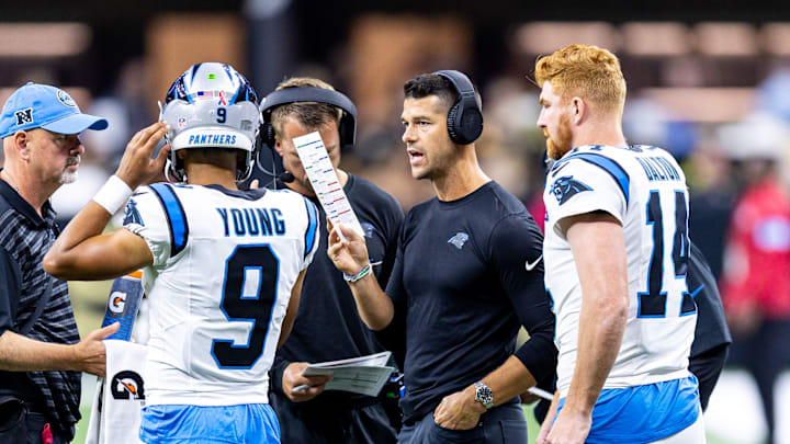 Sep 8, 2024; New Orleans, Louisiana, USA; Carolina Panthers head coach Dave Canales talks to quarterback Bryce Young (9) and quarterback Andy Dalton (14) on a time out against the New Orleans Saints during the first half at Caesars Superdome.