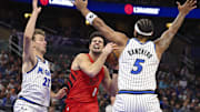 Nov 10, 2025; Orlando, Florida, USA; Portland Trail Blazers forward Deni Avdija (8) drives to the basket past Orlando Magic forward Franz Wagner (22) and forward Paolo Banchero (5) in the first quarter  at Kia Center. Mandatory Credit: Nathan Ray Seebeck-Imagn Images