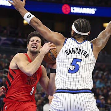 Nov 10, 2025; Orlando, Florida, USA; Portland Trail Blazers forward Deni Avdija (8) drives to the basket past Orlando Magic forward Franz Wagner (22) and forward Paolo Banchero (5) in the first quarter  at Kia Center. Mandatory Credit: Nathan Ray Seebeck-Imagn Images