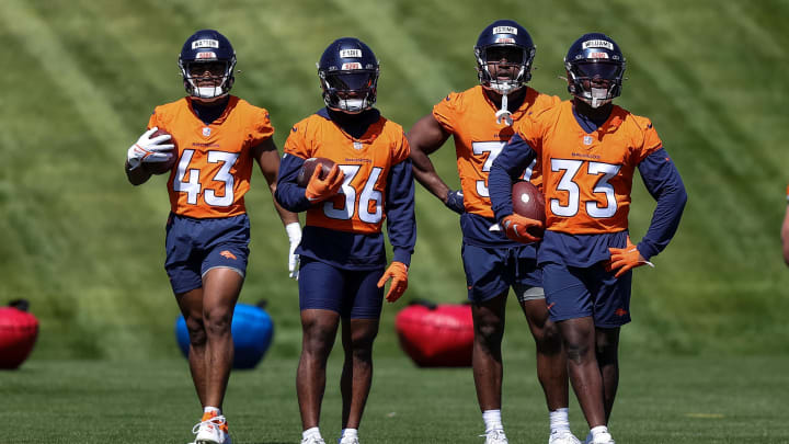 May 23, 2024; Englewood, CO, USA; Denver Broncos running back Blake Watson (43) and running back Tyler Badie (36) and running back Audric Estime (37) and running back Javonte Williams (33) look on as full back Michael Burton (20) runs a drill during organized team activities at Centura Health Training Center. 