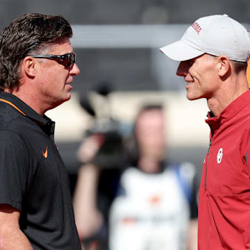 Oklahoma State head football coach Mike Gundy and Oklahoma head football coach Brent Venables talk before a Bedlam college football game between the Oklahoma State University Cowboys (OSU) and the University of Oklahoma Sooners (OU) at Boone Pickens Stadium in Stillwater, Okla., Saturday, Nov. 4, 2023.