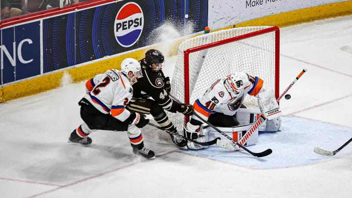 Bogdan Trineyev (44) tries to stuff the puck through Cal Peterson (40). The Lehigh Valley Phantoms played the Hershey Bears in the 1st game of the Calder Cup Semi-finals at the Giant Center in Hershey on May 1, 2024. The Bears won game one 2-1 and now lead the series 1-0.