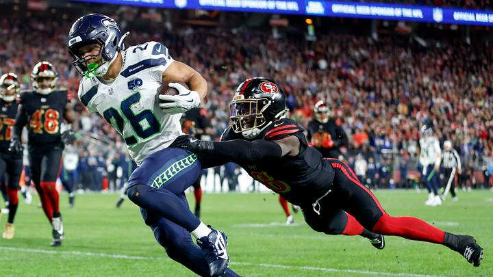 Seattle Seahawks running back Zach Charbonnet (L) and San Francisco 49ers safety Malik Mustapha (R)