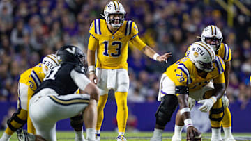 Nov 23, 2024; Baton Rouge, Louisiana, USA;  LSU Tigers quarterback Garrett Nussmeier (13) looks over the Vanderbilt Commodores defense during the first half at Tiger Stadium. Mandatory Credit: Stephen Lew-Imagn Images