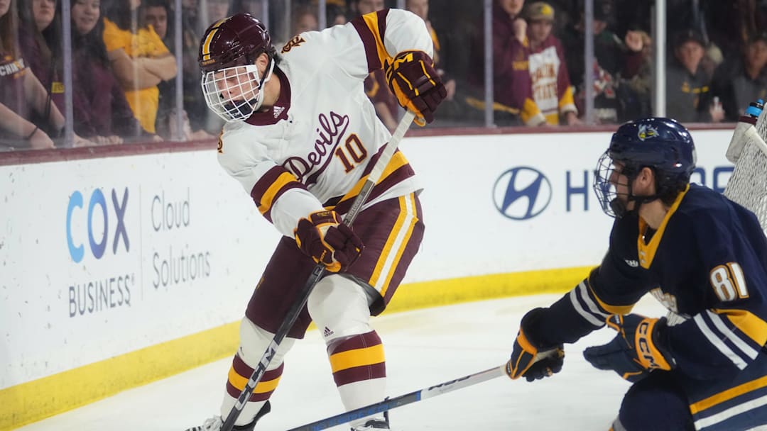ASU Sun Devils defenseman Tucker Ness (10) tries to get the puck past Augustana Vikings forward Owen Bohn (81) at Mullett Arena in Tempe on Jan. 19, 2024.