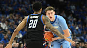 Feb 26, 2025; Omaha, Nebraska, USA;  Creighton Bluejays center Ryan Kalkbrenner (11) looks to pass against DePaul Blue Demons forward JJ Traynor (20) during the second half at CHI Health Center Omaha. Mandatory Credit: Steven Branscombe-Imagn Images