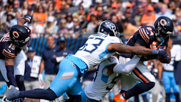 Chicago Bears running back Khalil Herbert (24) is taken down by Tennessee Titans linebacker Harold Landry III (58) and linebacker Ernest Jones IV (53) at Soldier Field in Chicago, Ill., Sunday, Sept. 8, 2024.